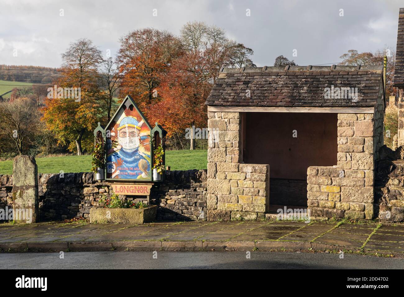 During lockdown traditional Peak District well dressings of flowers were cancelled so in the village of Longnor they painted this tribute to the NHS. Stock Photo