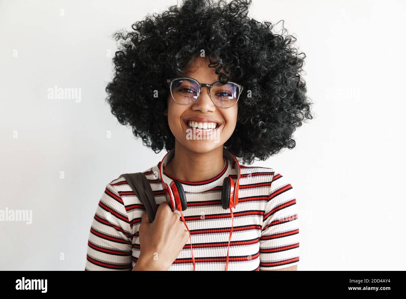 Happy african american student girl with headphones smiling at camera ...