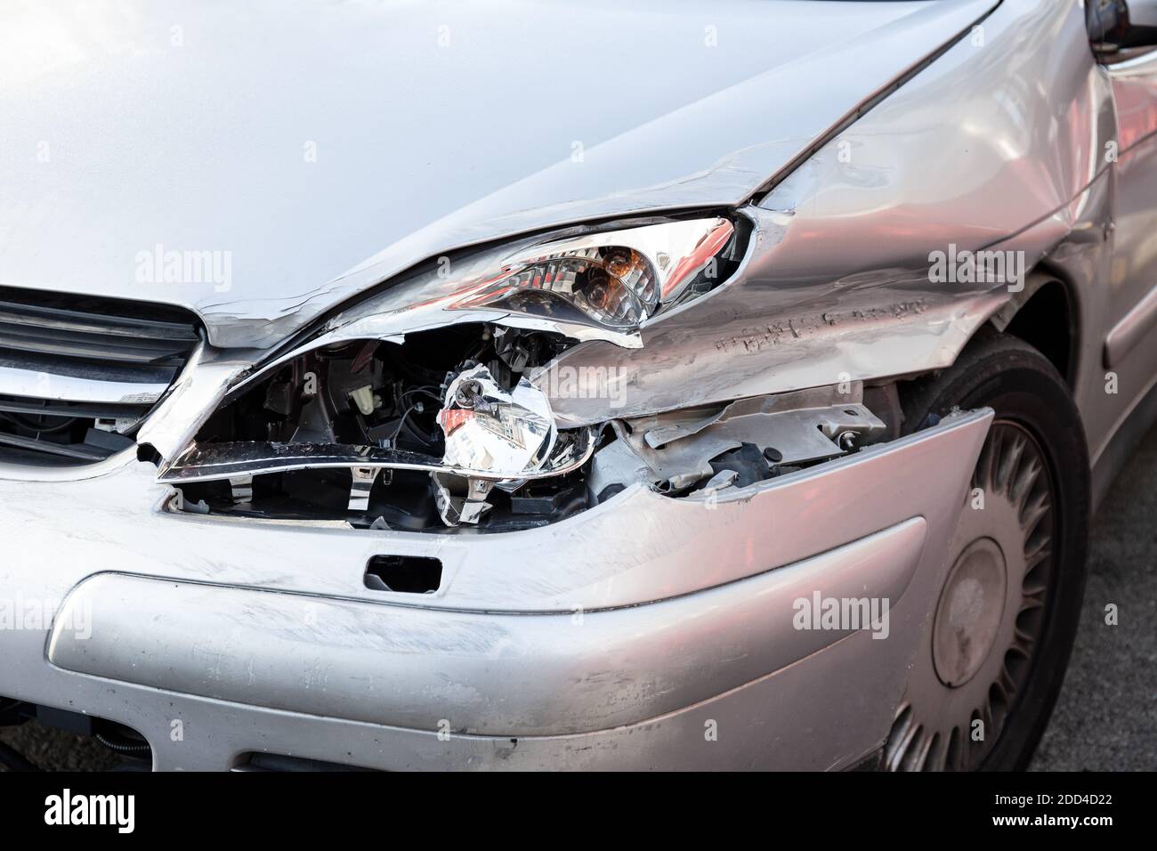 Car crash or accident. Front fender and light damage and scratches on bumper. Broken vehicle close up Stock Photo