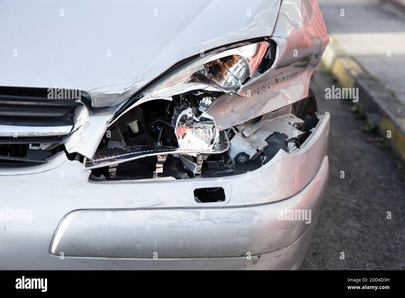 Car crash or accident. Front fender and light damage and scratches on bumper. Broken vehicle close up Stock Photo