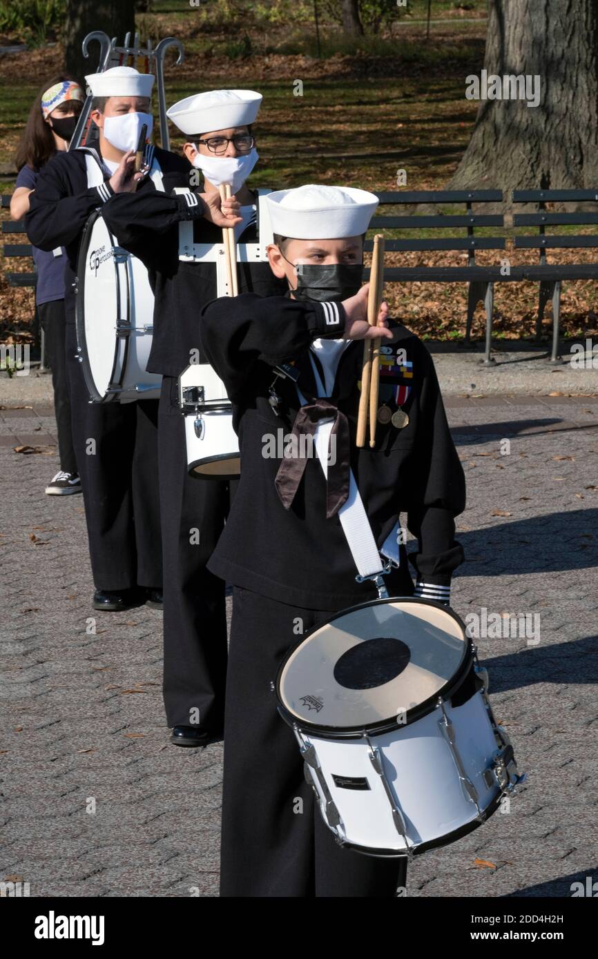 Teenagers in the US Naval Cadet Corps marching band rehearse near the Unisphere in Flushing Meadows Corona Park in Queens, New York City. Stock Photo