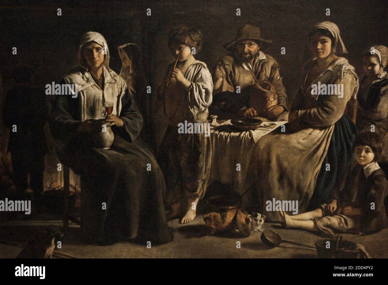 Louis Le Nain (1593-1648). French Baroque painter. Peasant family in an Interior. Nine members of a peasant family are shown grouped by the fire. Louvre Museum. Paris. France. Stock Photo