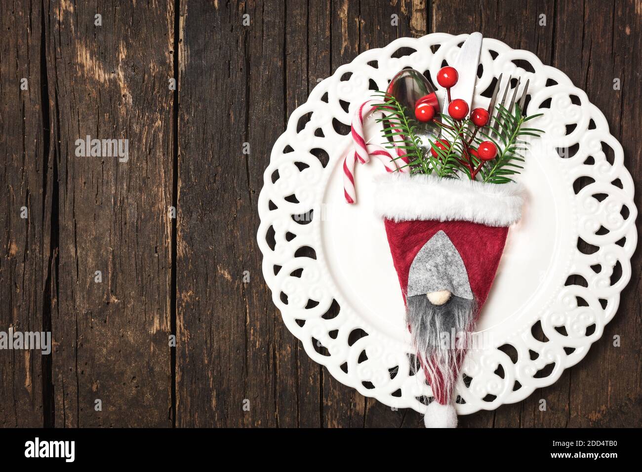 Christmas table place setting with Christmas decorations, top view with copy space. Winter Holidays background. Stock Photo
