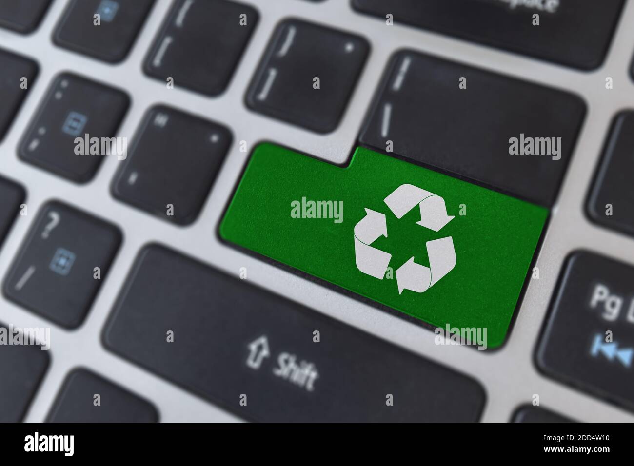 Save of environment concept. Logo recycle icon symbol on laptop keyboard. Stock Photo