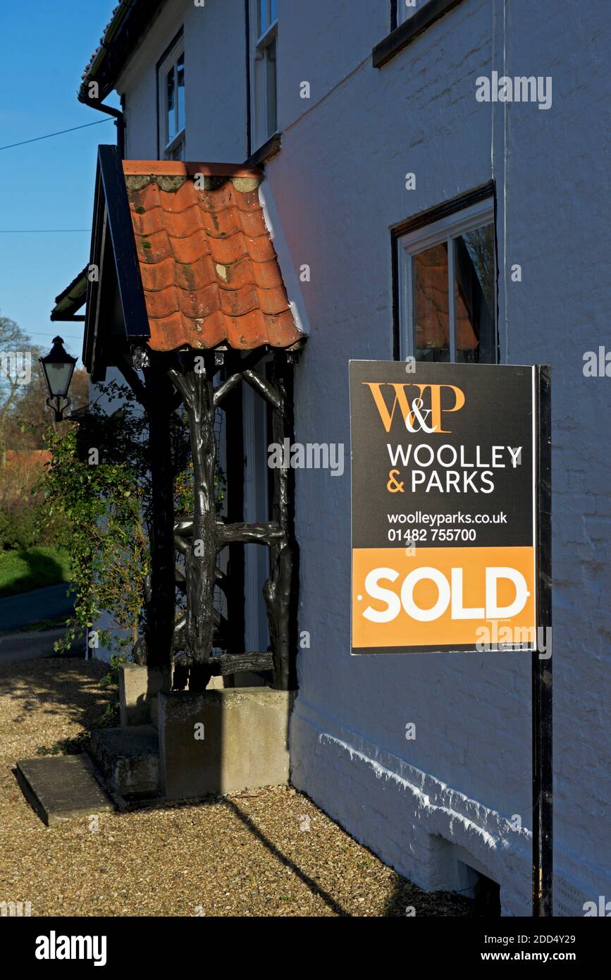 House For Sale sign outside property in Burton village, East
