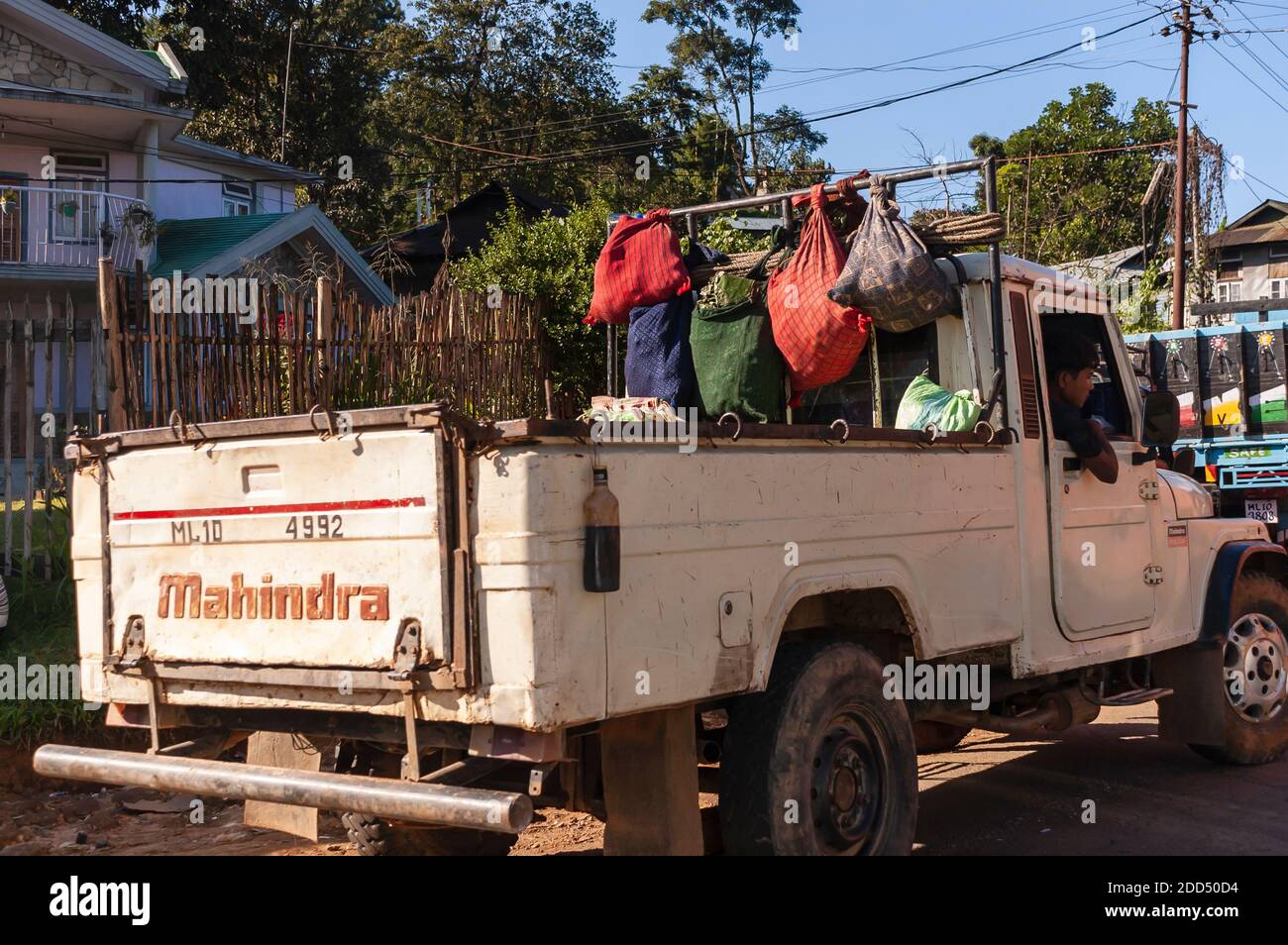 A driver of a Mahindra pickup truck waits by the roadside for the traffic jam to clear. Stock Photo