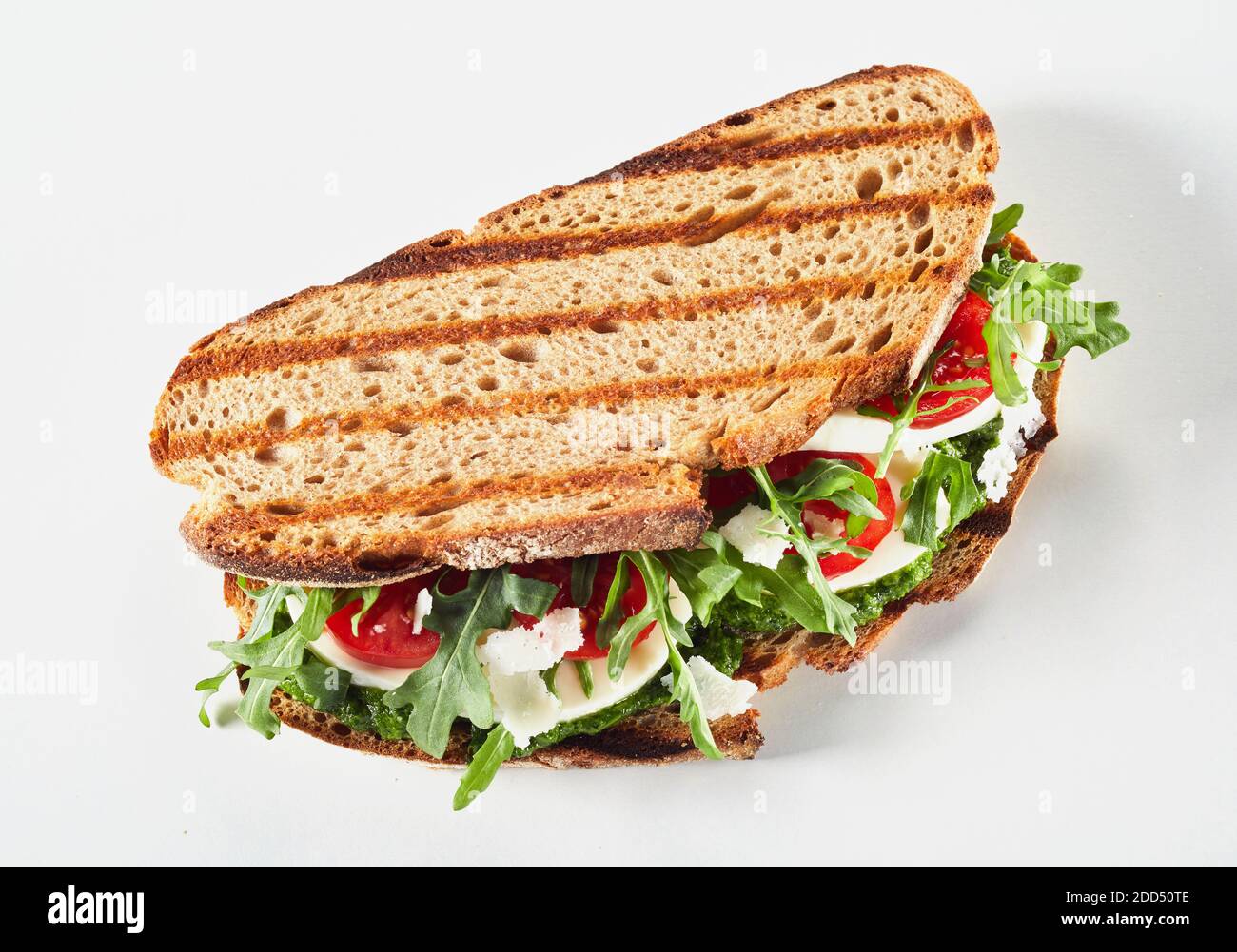 Grilled rye bread sandwich with rocket, tomato and mozzarella cheese