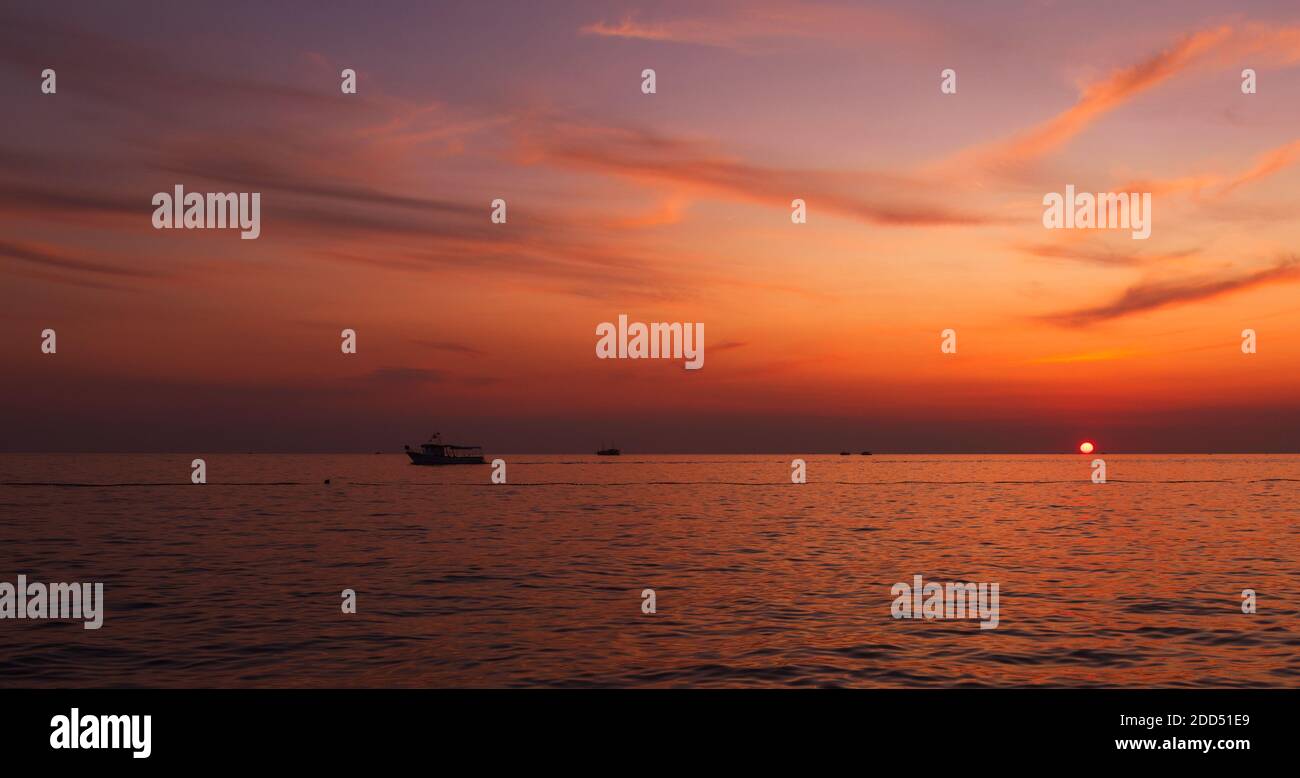 Touristic boats on open sea at beautiful golden sunset. Istria region, republic of Croatia Stock Photo