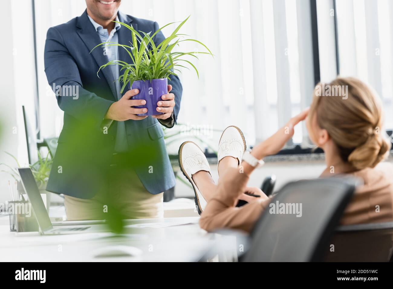 Woman crossed legs standing office hi-res stock photography and images ...