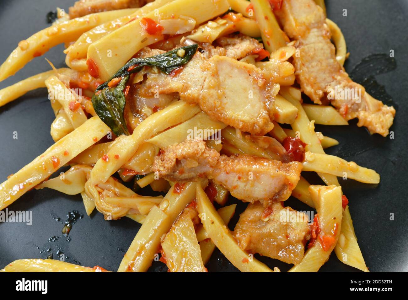 spicy stir fried bamboo shoot with crispy pork curry on plate Stock
