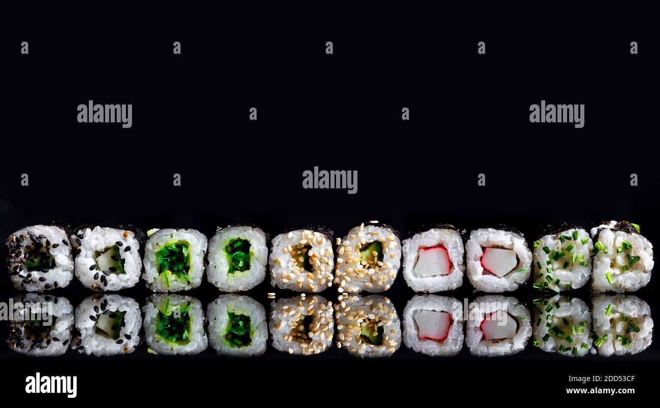 Sushi on a black background with the reflection. Macro photography Stock Photo
