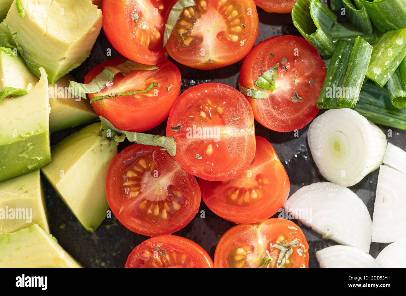 Salad - avocado, spring onion and tomato stock photo. Top View Stock Photo