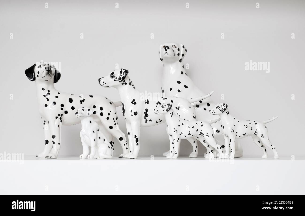 porcelain dalmatian dogs on white shelf in home interior Stock Photo