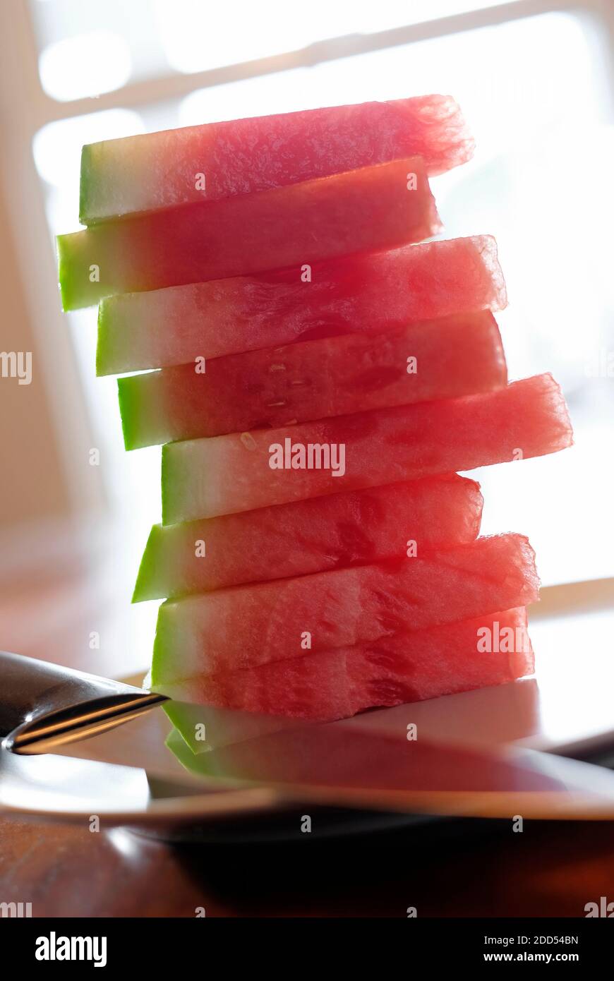 watermelon sliced segments on plate in home interior Stock Photo