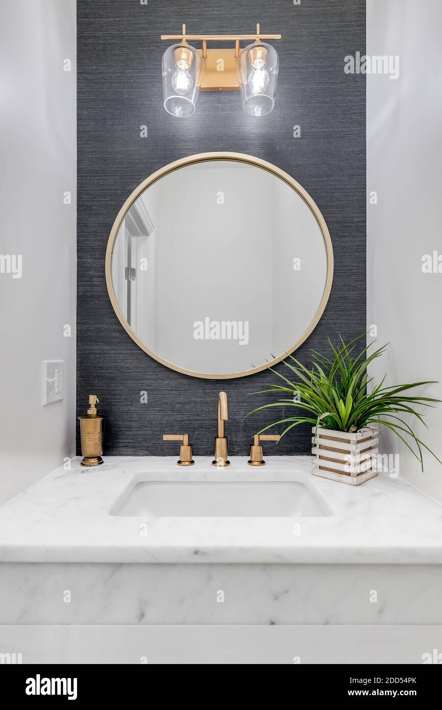 A small bathroom with grey wallpaper, gold hardware, and a white marble counter top Stock Photo - Alamy A small bathroom with grey wallpaper, gold hardware, and a white marble counter top Stock Photo - Alamy