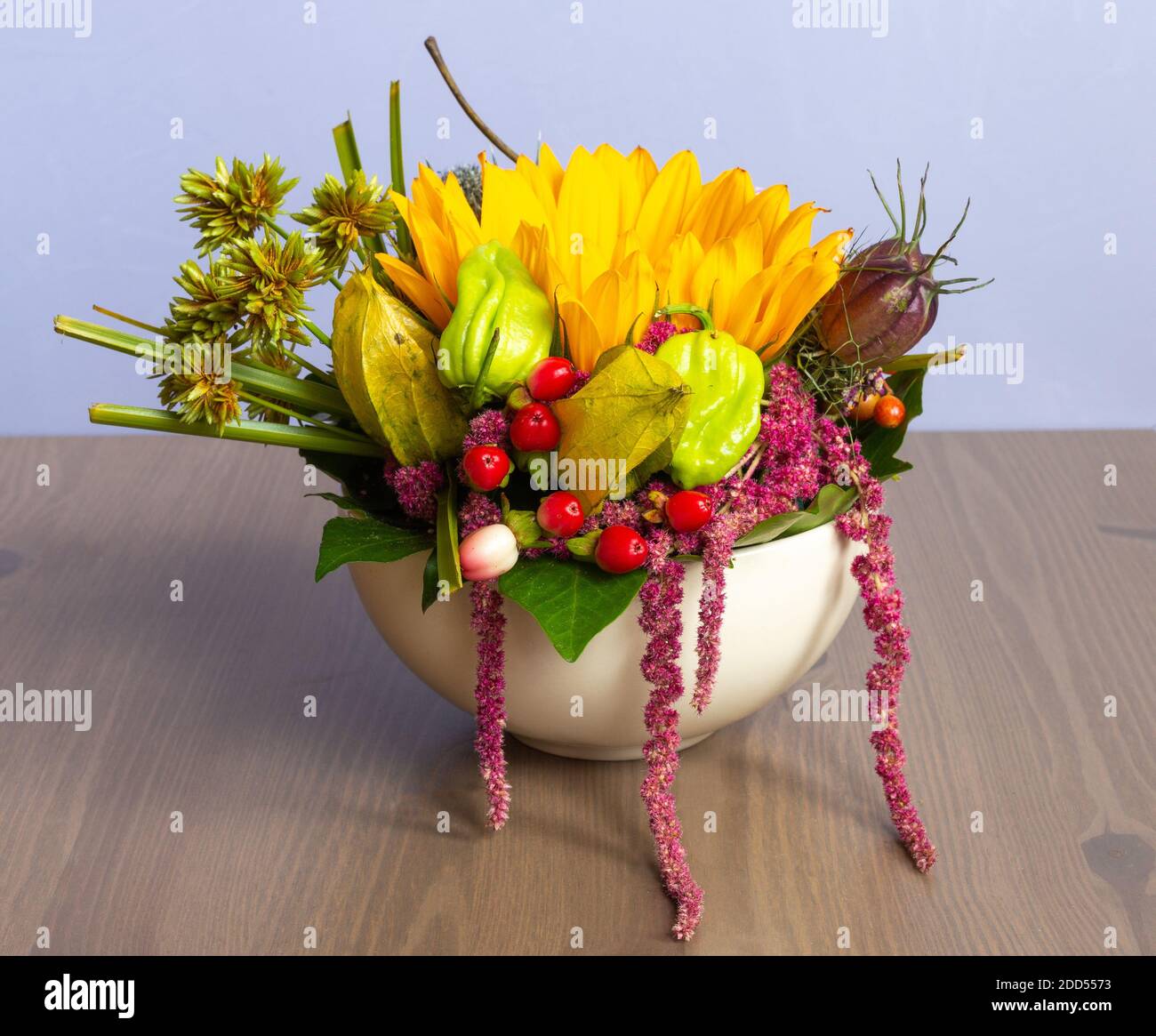 Various Summer Flowers In White Flowerpot  On Wooden Table Stock Photo