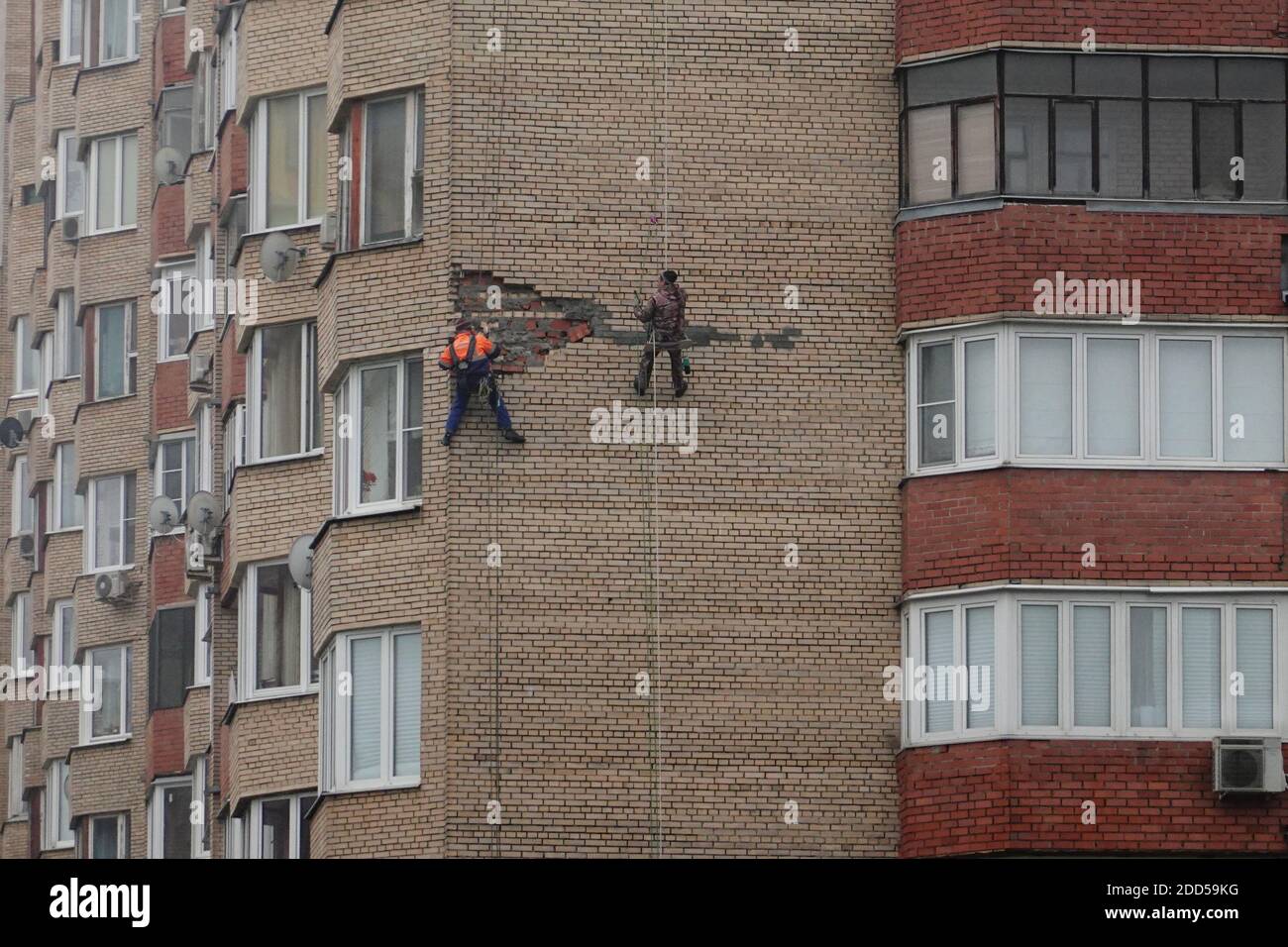 Building Getting Repaired Workers repair facade of house building Stock Photo - Alamy