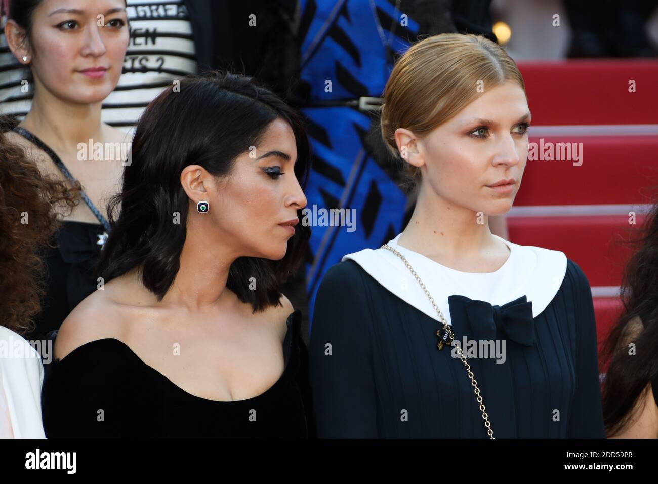 Filmmakers, actresses and producers raise their arms as clap after the Australian actress and President of the Jury Cate Blanchett with other filmmakers read a statement on the steps of the red carpet in protest of the lack of female filmmakers honored throughout the history of the festival at the screening of 'Girls of The Sun (Les Filles Du Soleil)' during the 71st annual Cannes Film Festival at the Palais des Festivals on May 12, 2018 in Cannes, southeastern France. - Only 82 films in competition in the official selection have been directed by women since the inception of the Cannes Film Fe Stock Photo