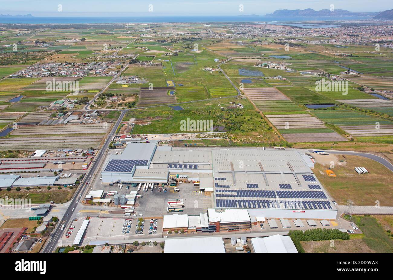 Cape Town, Western Cape / South Africa - 10/26/2020: Aerial photo of Spar Distribution Centre with False Bay in the background Stock Photo