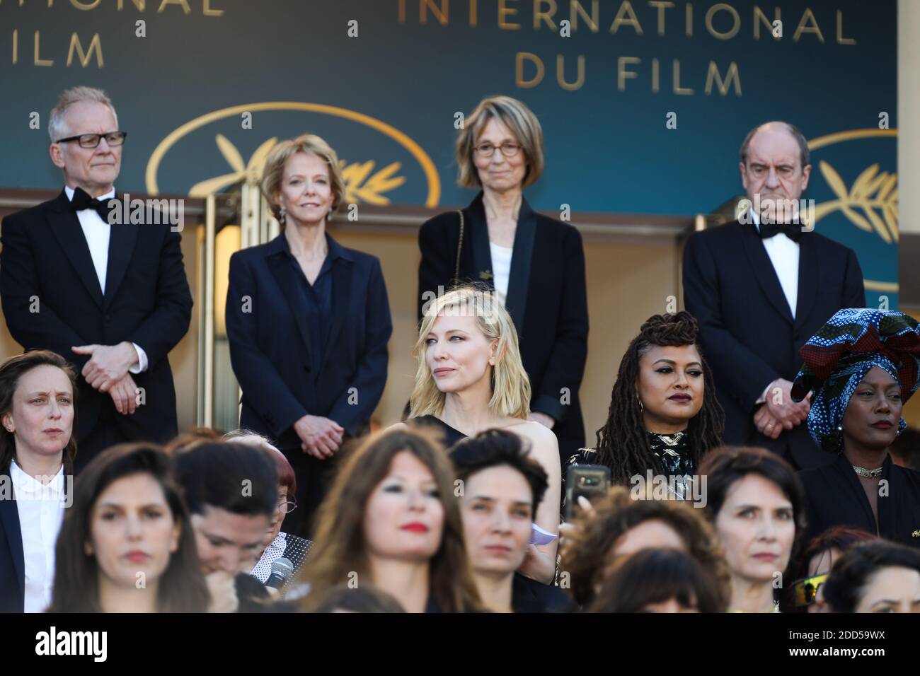 Filmmakers, actresses and producers raise their arms as clap after the Australian actress and President of the Jury Cate Blanchett with other filmmakers read a statement on the steps of the red carpet in protest of the lack of female filmmakers honored throughout the history of the festival at the screening of 'Girls of The Sun (Les Filles Du Soleil)' during the 71st annual Cannes Film Festival at the Palais des Festivals on May 12, 2018 in Cannes, southeastern France. - Only 82 films in competition in the official selection have been directed by women since the inception of the Cannes Film Fe Stock Photo