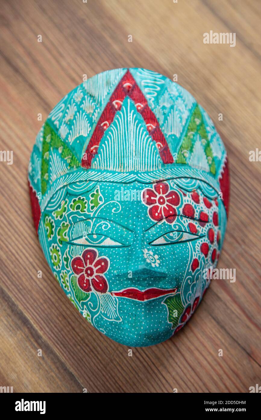 Traditional Asian Decorated Heritage Wooden Mask | Malaysian Painted Mask on wooden table Stock Photo