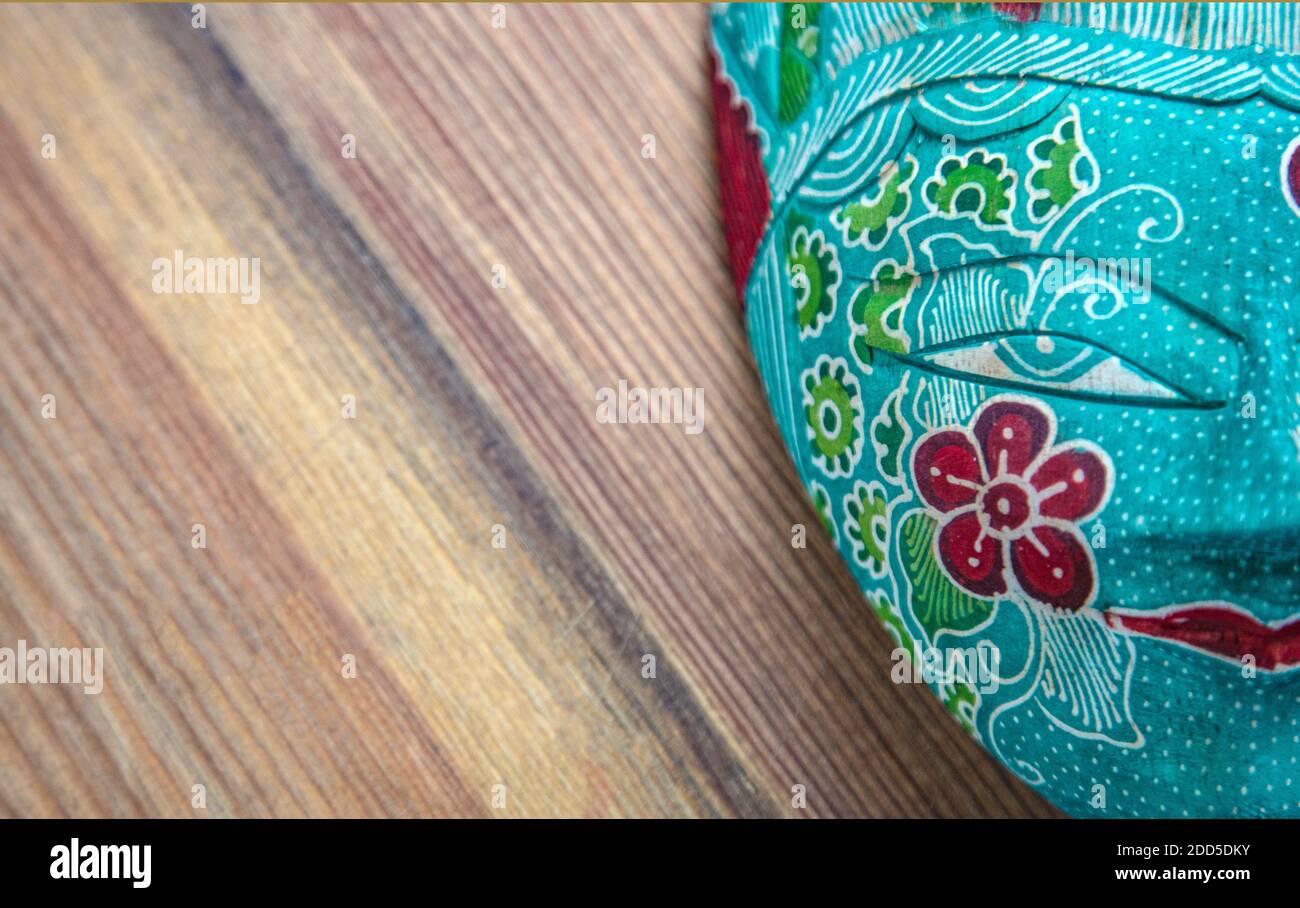 Traditional Asian Decorated Heritage Wooden Mask | Malaysian Painted Mask on wooden table Stock Photo