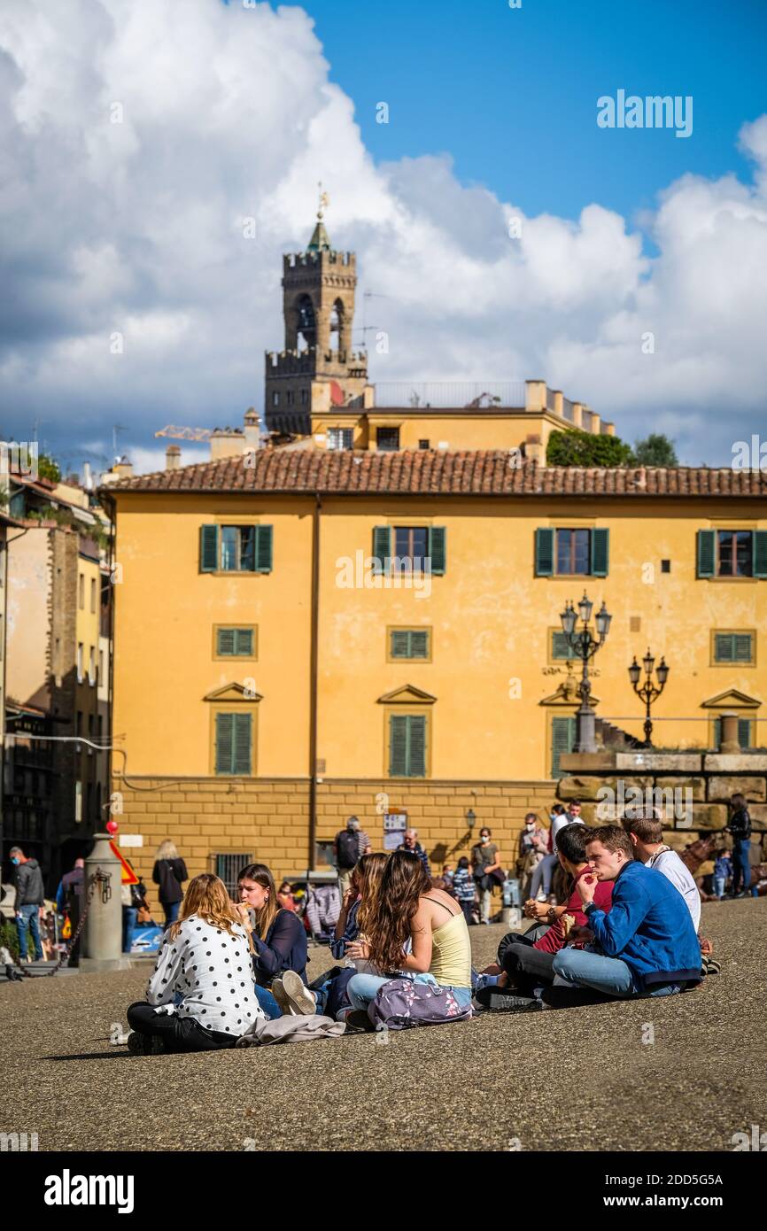 2020 October 17, Florence Italy: Tourists seated near the Palazzo Pitti or the Pitti Palace, is a vast Renaissance palace in Florence, Italy Stock Photo