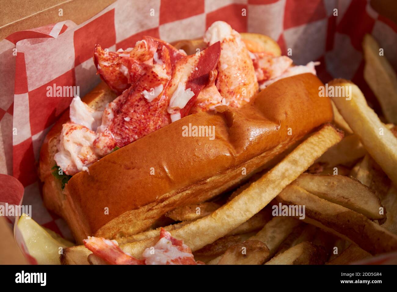 A New England style hot dog bun, stuffed for a classic, iconic lobster