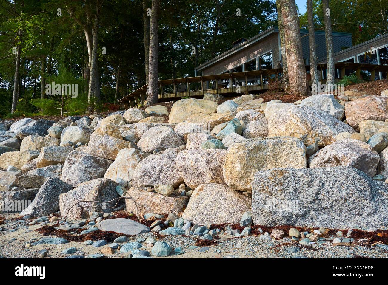 pix Rip Rap Retaining Wall Detail https www alamy com a manmade wall of rocks stones riprap lines a shoreline the project is errosion remediation due to climate change global warming in surry maine image386742098 html