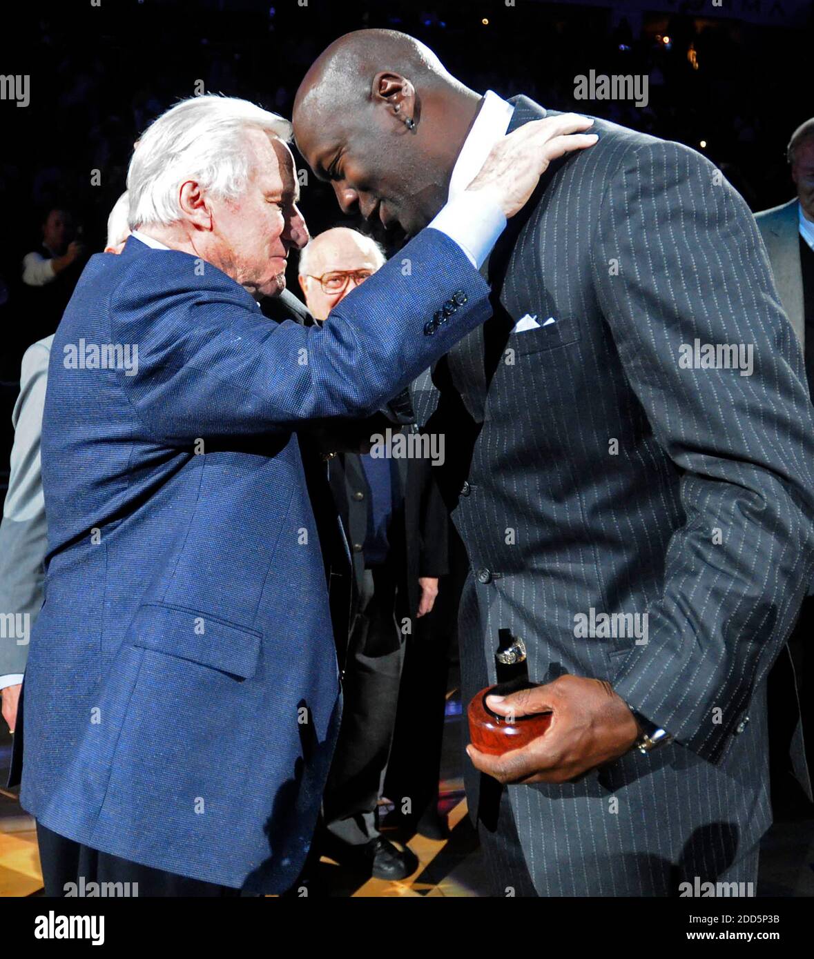 NO FILM, NO VIDEO, NO TV, NO DOCUMENTARY - Former North Carolina coach Dean Smith congratulates Charlotte Bobcats majority owner, and former player, Michael Jordan after Jordan was inducted into the North Carolina Sports Hall of Fame at halftime of the NBA Basketball match, Bobcats vs Toronto Raptors at the Time Warner Cable Arena in Charlotte, NC, USA on December 14, 2010. Photo by David T. Foster III/Charlotte Observer/MCT/ABACAPRESS.COM Stock Photo