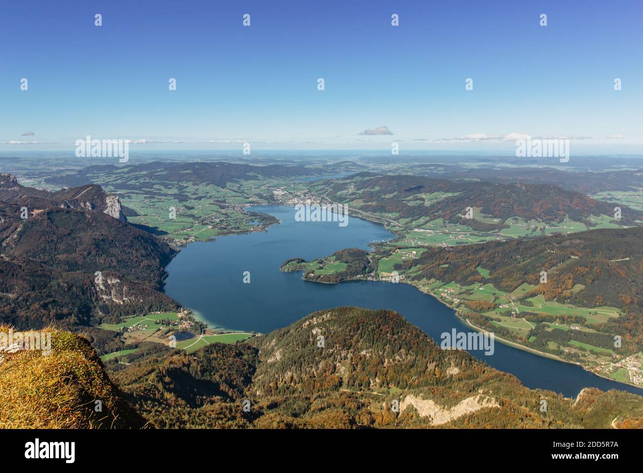 View of lake Mondsee from top of Schafberg,Austria,Salzkammergut region.Blue sky, Alps mountains,Salzburg, nearby Wolfgangsee, Attersee.Hiking in Alps Stock Photo