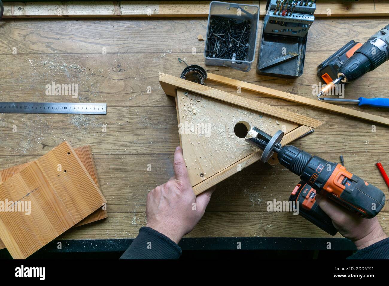 Amateur carpenter with wooden birdhouse. Stock Photo