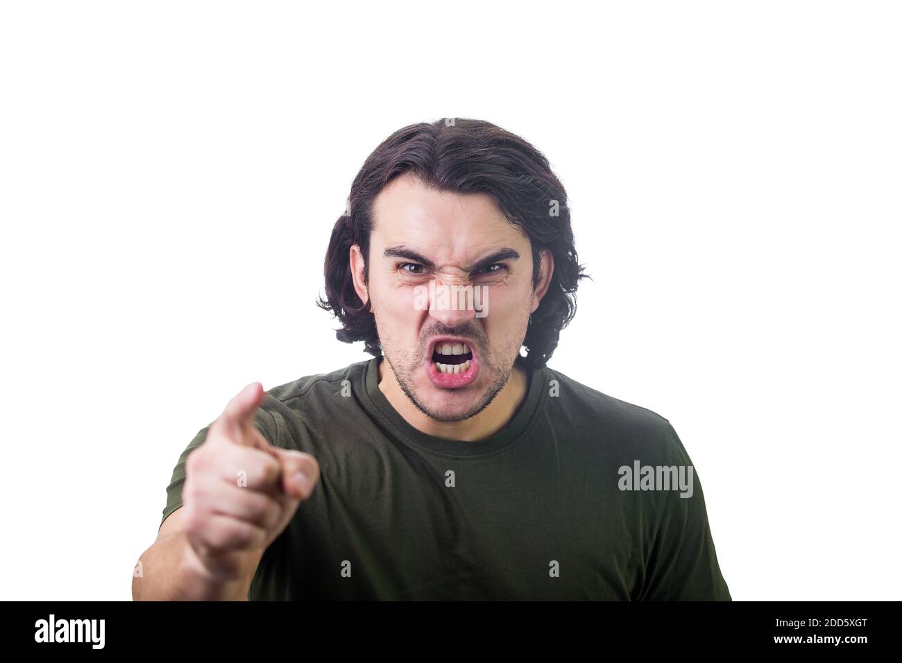 Furious young man pointing forefinger to camera blaming someone as guilty, or scolding isolated on white background. Angry guy screaming and showing w Stock Photo
