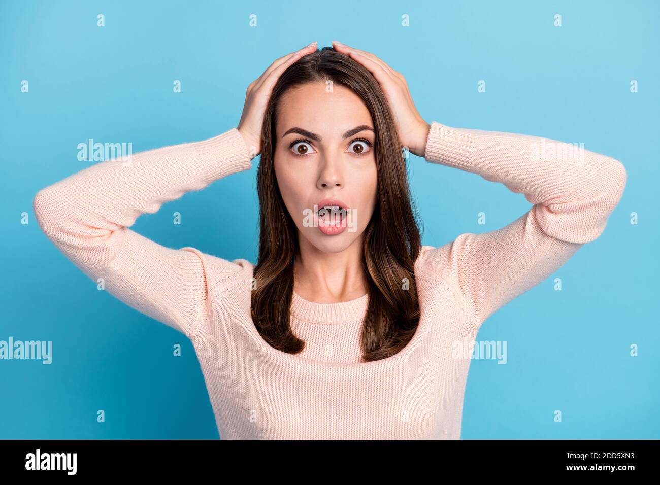 Portrait of astonished anxious girl touch hand head open mouth isolated ...