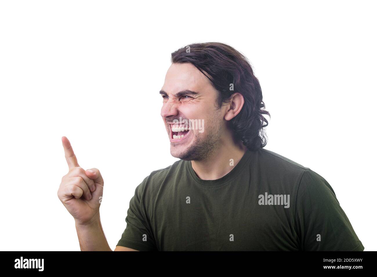 Angry young man reacting furious clenching teeth screaming and shaking his index finger. Irritated and annoyed guy negative facial expression, blaming Stock Photo