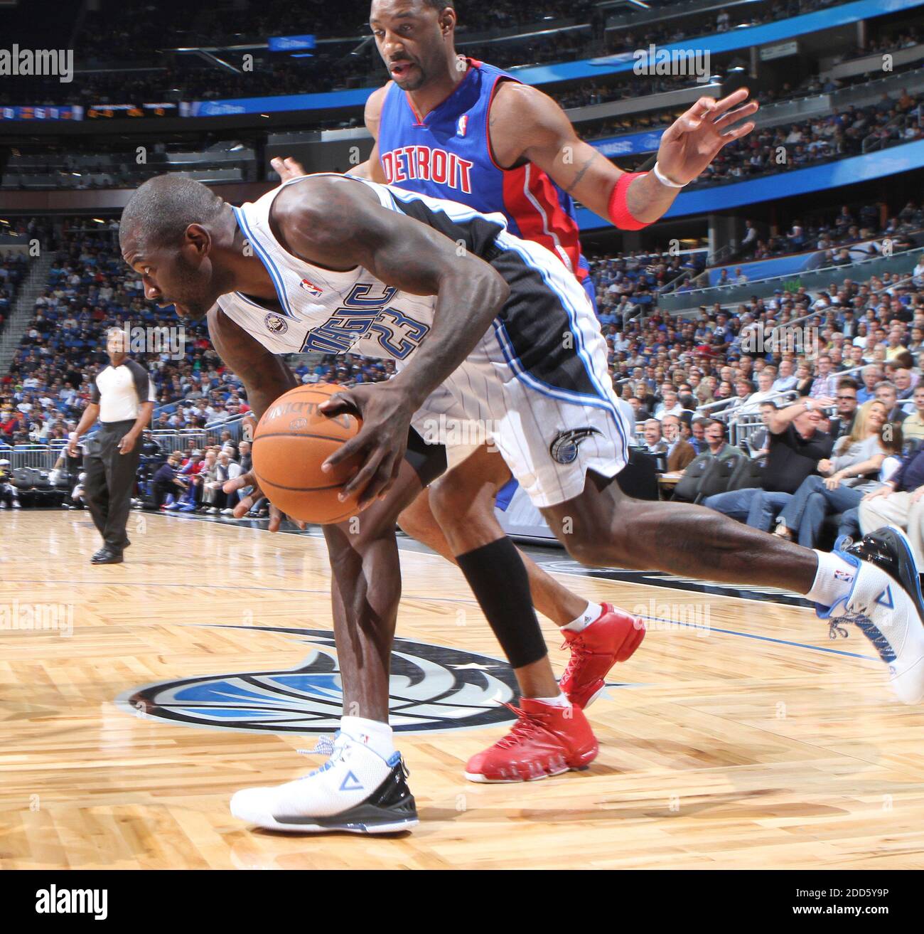 NO FILM, NO VIDEO, NO TV, NO DOCUMENTARY - Orlando Magic guard Jason  Richardson (23) is tripped up by Detroit Pistons guard Tracy McGrady (1)  along the baseline in the first half