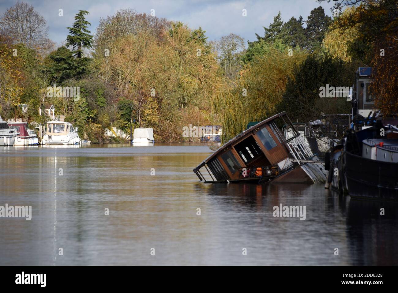 A sunken boat at an angle along the beautiful River Thames near Old Windsor Stock Photo