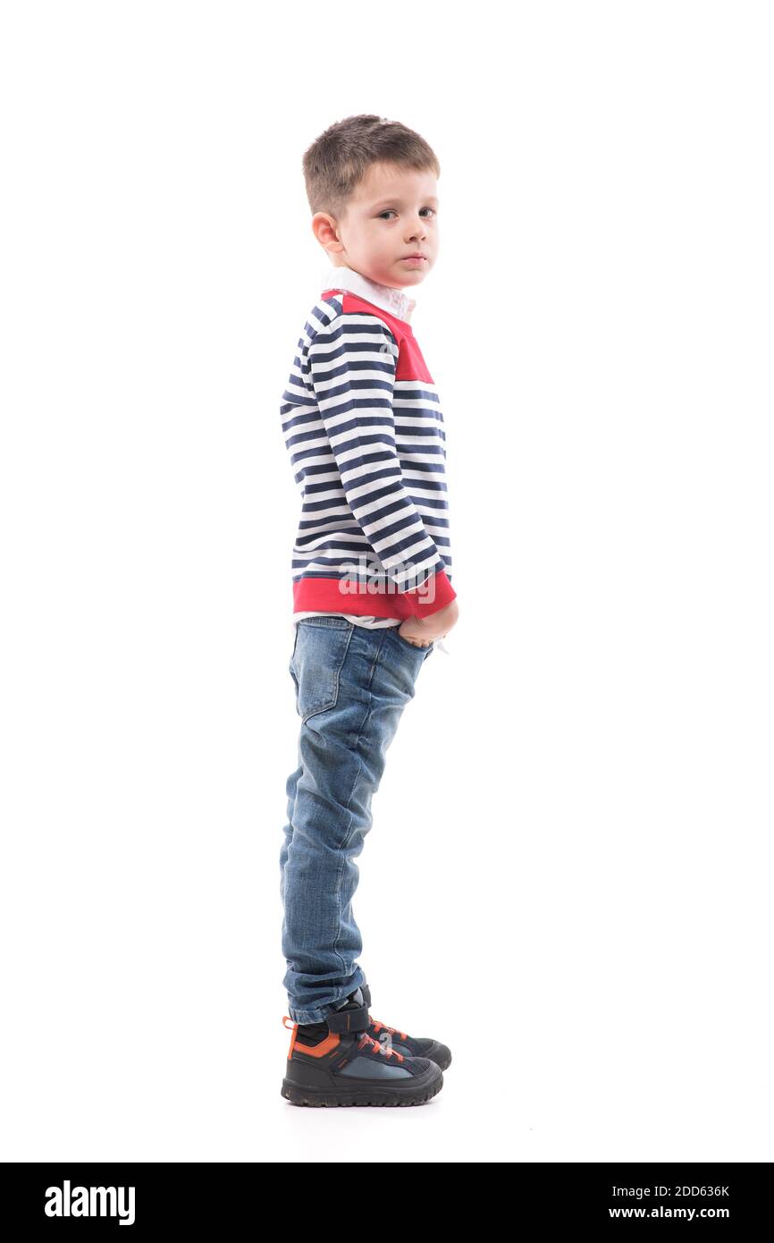 Side view of cool confident cute young preschooler kid standing with hands  in pockets. Full body portrait isolated on white background Stock Photo -  Alamy