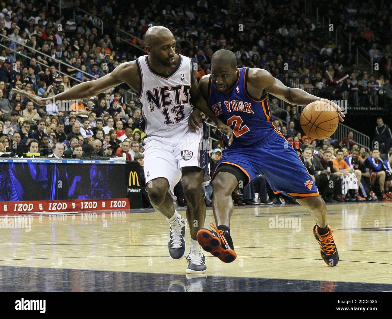 Raymond Felton, right, of the New York Knicks drives against Quinton Ross  of the New Jersey Nets at the Prudential Center in Newark, New Jersey, on  Saturday, February 12, 2011. The Knicks