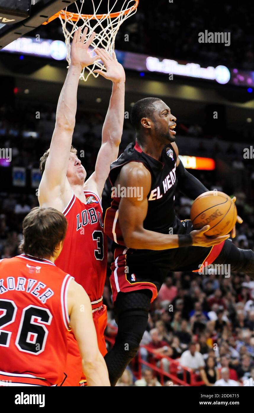 NO FILM, NO VIDEO, NO TV, NO DOCUMENTARY - Miami Heat's Dwyane Wade makes a spin move to the basket past the Chicago Bulls Kyle Korver and Omar Asik in the fourth during the NBA Basketball match, Chicago Bulls vs Miami Heat at the American Airlines Arena in Miami, FL, USA on March 6, 2011. The Bulls won, 87-86. Photo by Joe Cavaretta/Sun Sentinel/MCT/ABACAPRESS.COM Stock Photo