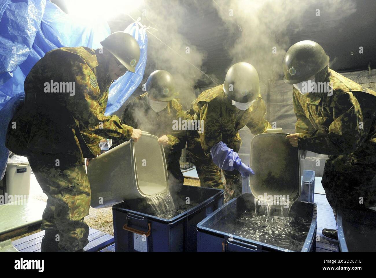 NO FILM, NO VIDEO, NO TV, NO DOCUMENTARY - GSDF ready reserve personnel prepare hot water for a temporary bathing facility, in Japan, on March 26, 2011. Photo by Yomiuri Shumbun/MCT/ABACAPRESS.COM Stock Photo