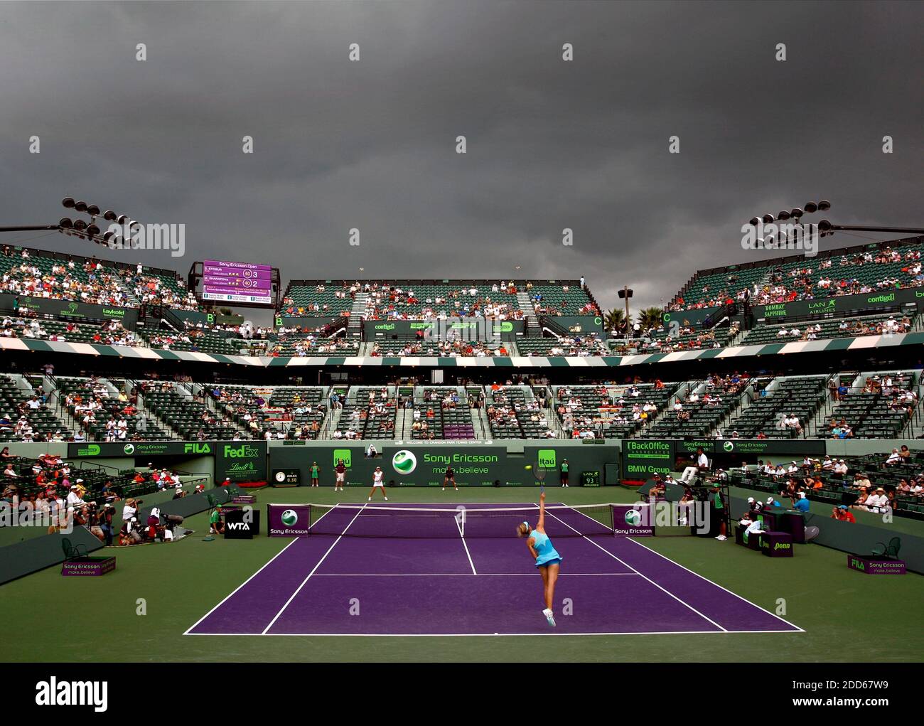 NO FILM, NO VIDEO, NO TV, NO DOCUMENTARY - Heavy storm clouds hover over  the Tennis Center as Maria Sharapova of Russia serves to Samantha Stosur of  Australia during the Sony Ericsson