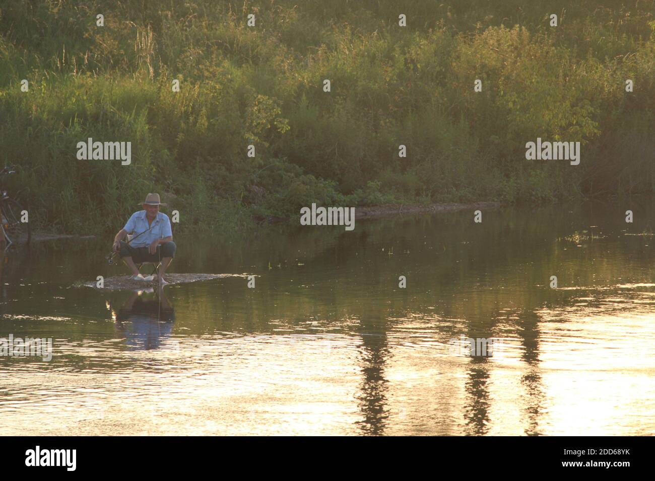 stranded fisherman in flooded river Stock Photo Alamy