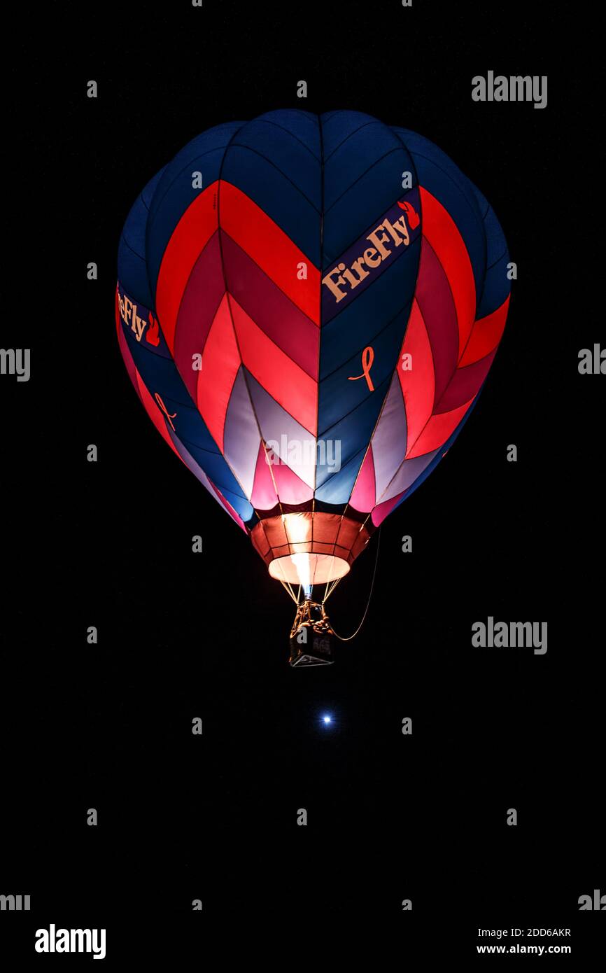 Hot air balloon flying during Dawn Patrol, Albuquerque International Balloon Fiesta, Albuquerque, New Mexico USA Stock Photo