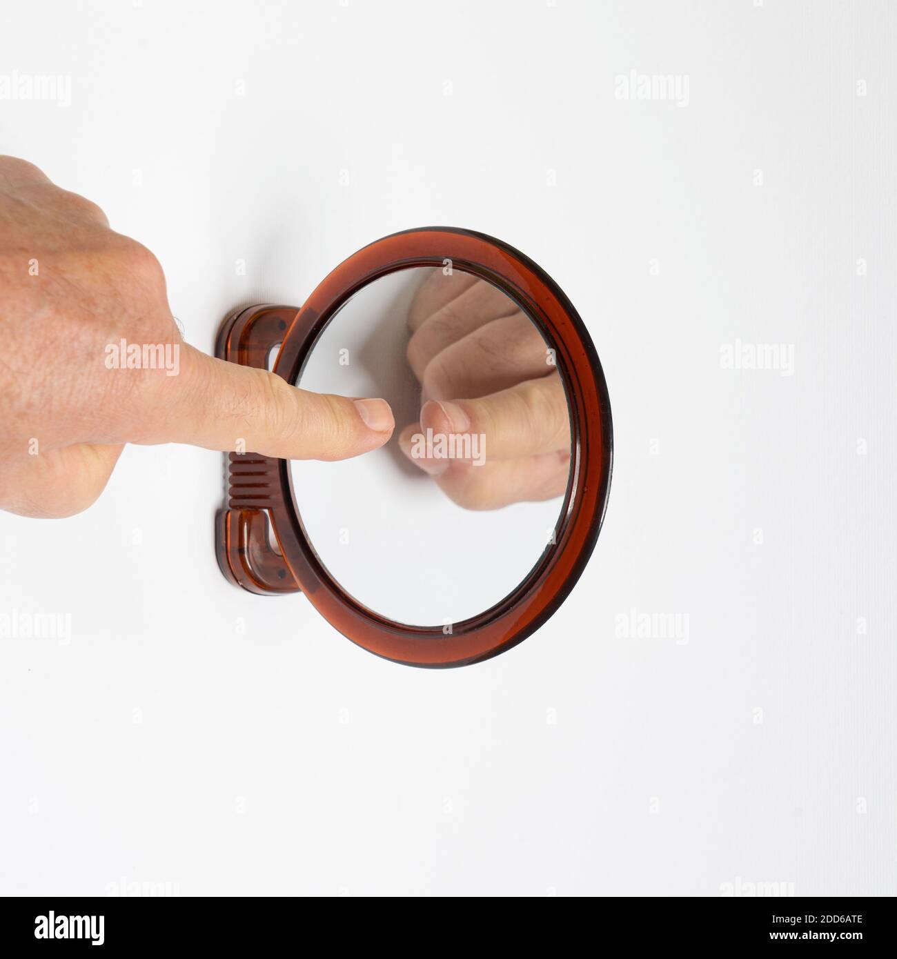 touch your ego with your hand on a mirror Stock Photo