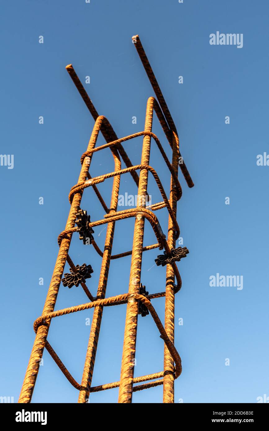 Pillar rebars against sky. Construction site with steel reinforcing