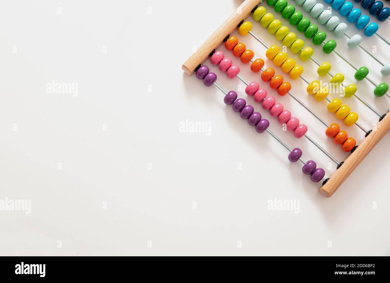 School abacus with colorful beads on white color background, close up view, copy space. Kids learning count, children math class concept Stock Photo