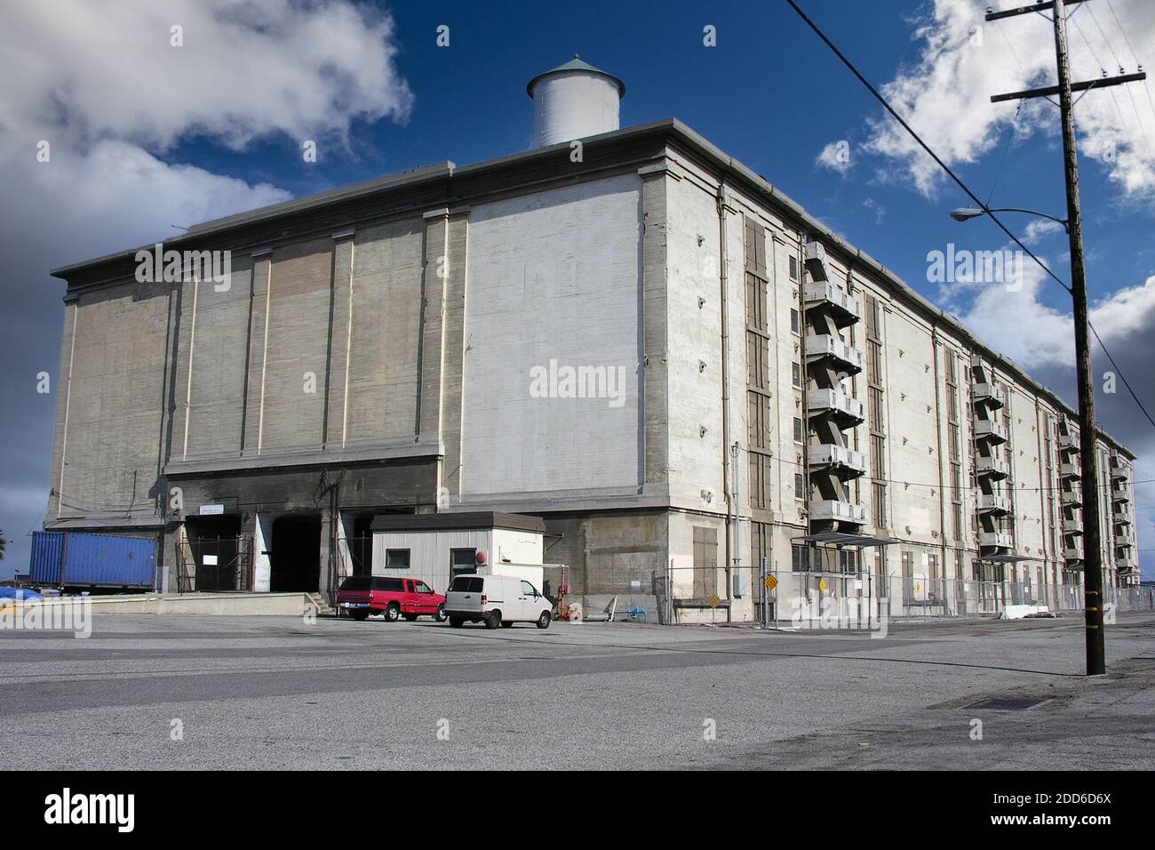 Old seaside concrete warehouse building near port and harbor facilities. Stock Photo
