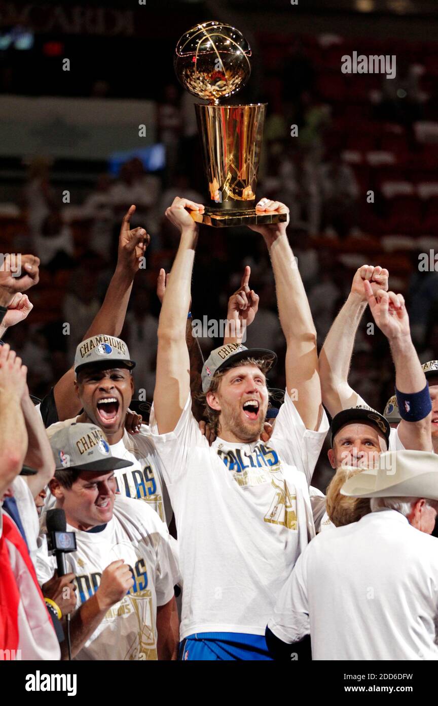 Dirk Nowitzki of the Mavericks holds the championship trophy after  defeating the Heat during Game 6 of the NBA Finals at the AmericanAirlines  Arena in Miami, Florida, Sunday, June 12, 2011. The