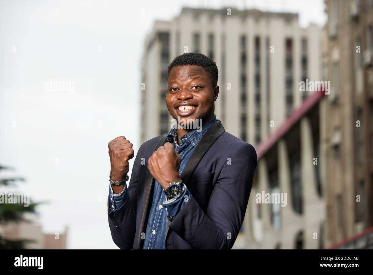 Happy businessman raising his fists in the gesture of winning and ...